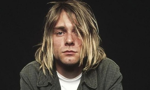 Retrato de Kurt Cobain con el cabello largo tapando parcialmente su rostro.